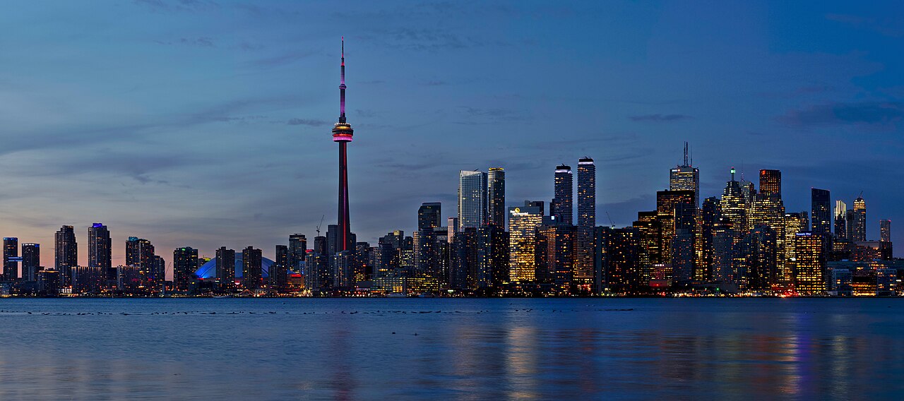 The Toronto tower rising over the downtown skyline at sunset